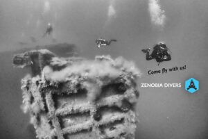 SCUBA divers floating around the Zenobia Wreck