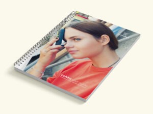 Front cover showing young woman using the coMra Palm device